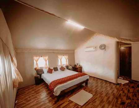 Deluxe room with a king-size bed and framed artwork