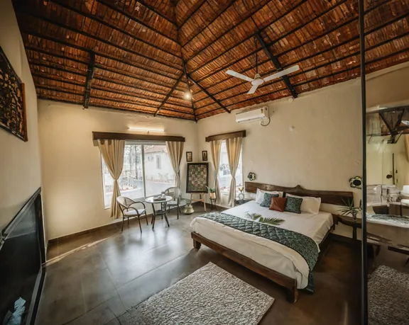 Cottage bedroom with a king-size bed and a wooden-beam ceiling
