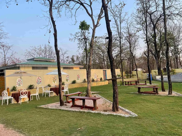 Lawn dining set-up under the trees at Palash Jungle Resort