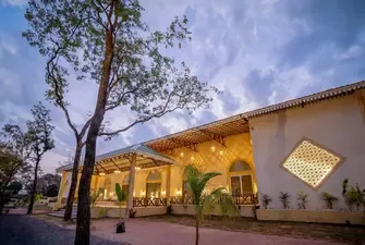 Banquet hall at Palash Jungle Resort lit up in the evening