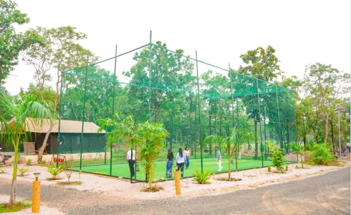 Net-enclosed sports court at Palash Jungle Resort