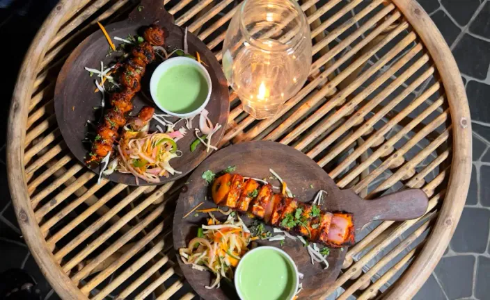 Barbecue platters with grilled skewers and chutneys