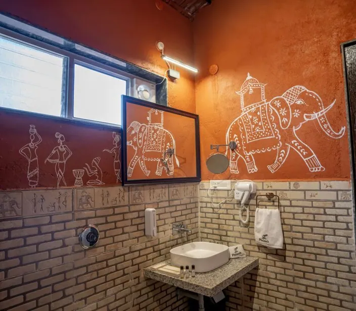Bathroom with a hand-painted elephant mural