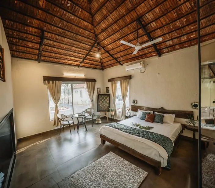 Cottage bedroom with a king-size bed and a wooden-beam ceiling