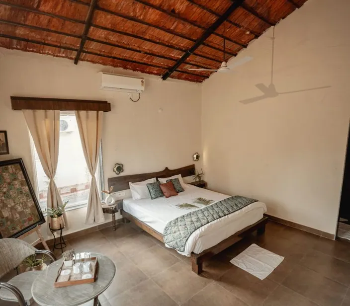 Cottage bedroom with a king-size bed and framed art
