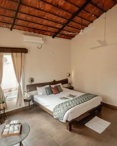 Cottage bedroom with a king-size bed and framed art