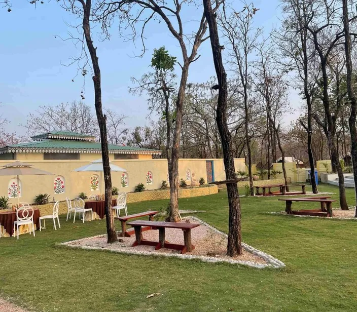 Lawn dining set-up under the trees at Palash Jungle Resort