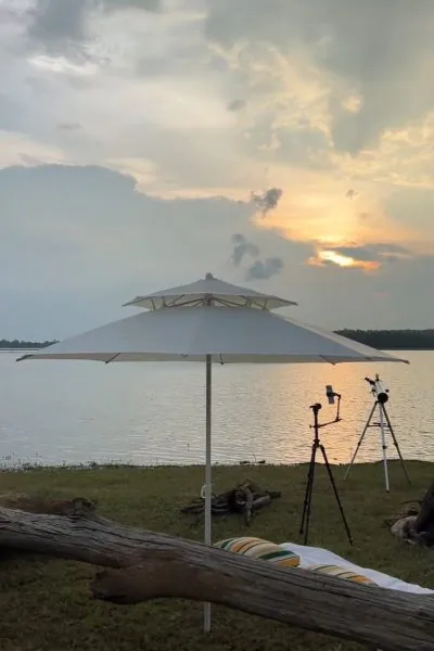 Sunset over the lake with an umbrella and telescopes